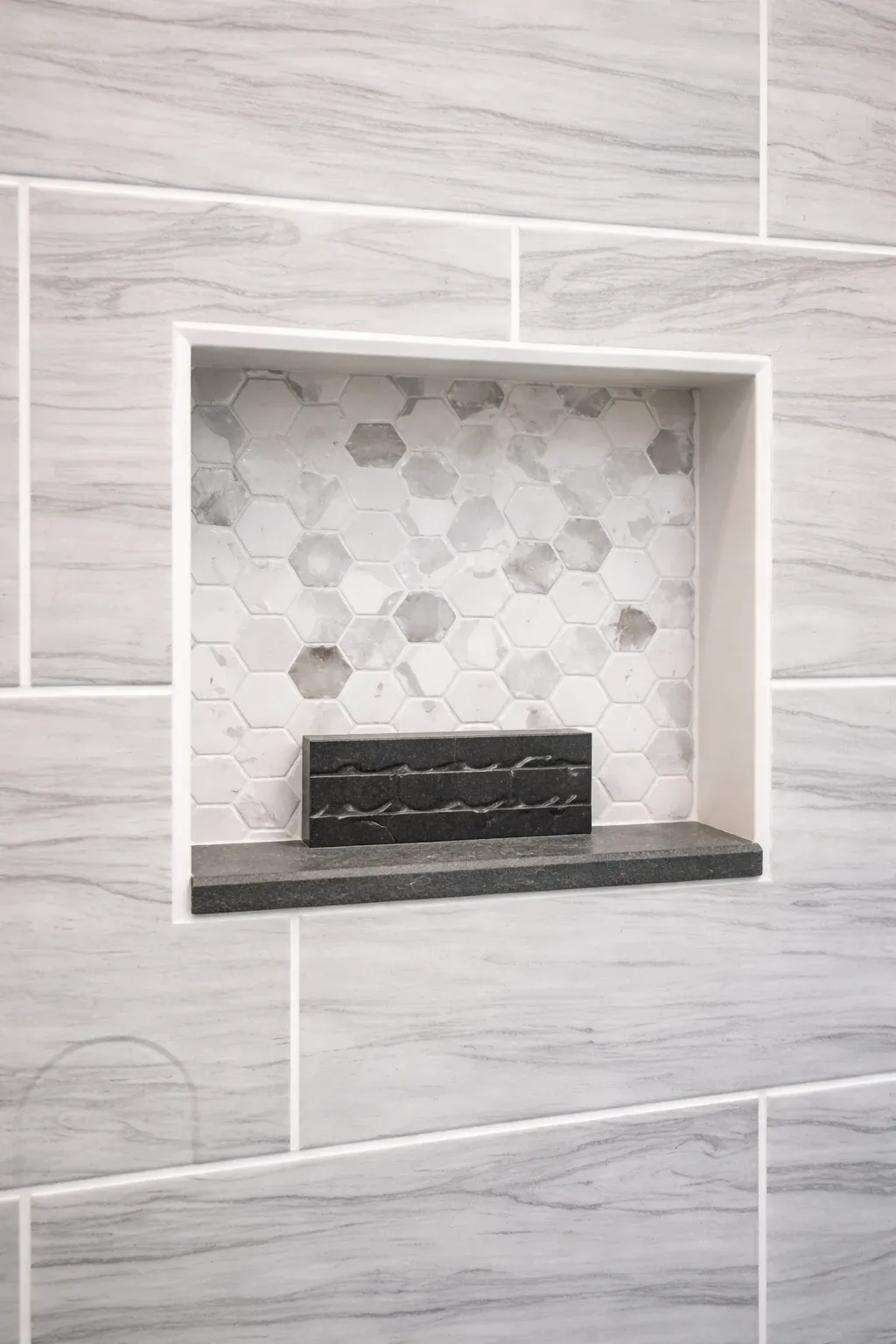 Mosaic tile shower niche detail showing bathroom tile installation in NJ